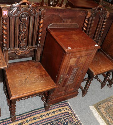 Lot 1228 - A Victorian oak beside cupboard with four carved oak dining chairs (5)