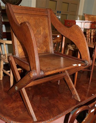 Lot 1247 - A Victorian oak Glastonbury style armchair labelled Howard's Patented parquetry number 1548