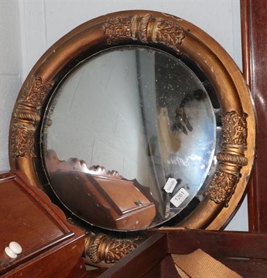 Lot 1261 - A Regency gilt and ebonised convex mirror