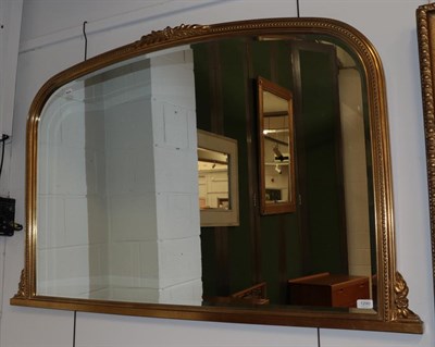 Lot 1290 - A large reproduction gilt over mantel mirror, arched frame
