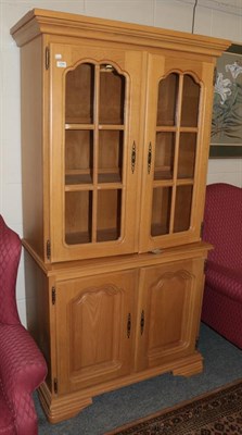 Lot 1296 - A reproduction oak display cabinet with two glazed doors and two cupboard doors