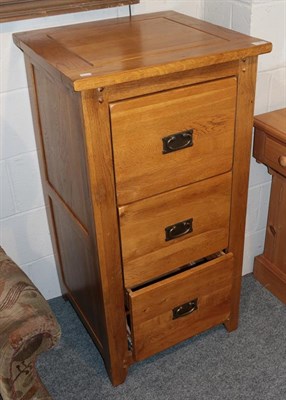 Lot 1324 - A reproduction oak three drawer filing cabinet