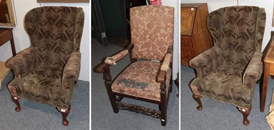 Lot 1325 - A boldly carved oak part-upholstered open armchair and a pair of 1920's mahogany framed wing...