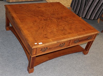 Lot 1334 - A reproduction walnut coffee table with four fitted drawers