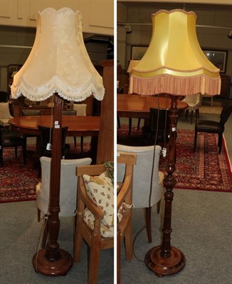 Lot 1341 - A mahogany standard lamp (adapted from a bed post) and a walnut standard lamp