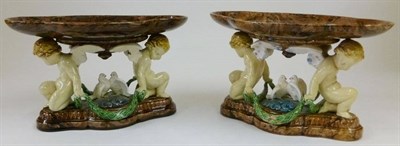 Lot 54 - A Matched Pair of Minton Majolica Tazzas, 1862 and 1864, the marbled lobed oval tops supported by a