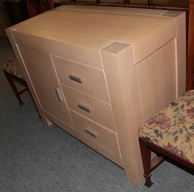 Lot 1361 - A modern limed oak cabinet fitted with three short drawers next to a cupboard door, 90cm high...