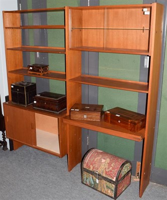 Lot 1146 - A 1970's teak free standing bookcase with sliding glass doors and cupboard base