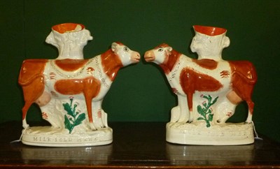 Lot 76 - A Pair of Staffordshire Pottery Advertising Spill Vases, 19th century, as cows standing four square
