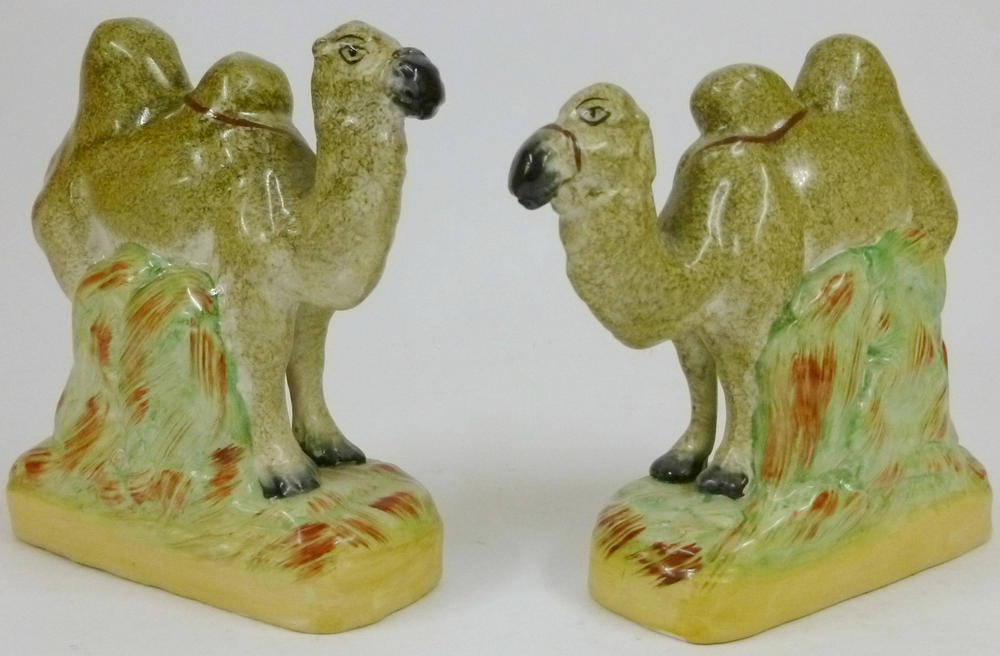 Lot 77 - A Pair of Staffordshire Pottery Figures of Bactrian Camels, 19th century, each standing four...