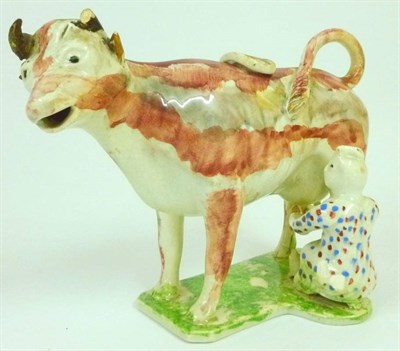 Lot 79 - A Pearlware Pottery Cow Creamer Group, probably Staffordshire, circa 1820, the standing beast...