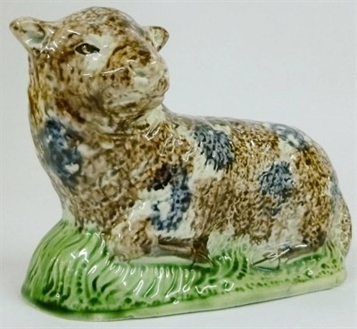 Lot 86 - A Creamware Model of a Recumbent Sheep, late 18th century, with blue and brown sponged...
