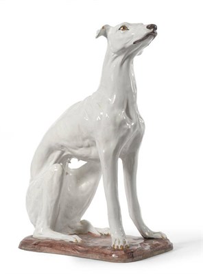 Lot 111 - A Pair of Faience Models of Seated Hounds in 19th Century Italian Style, naturalistically...