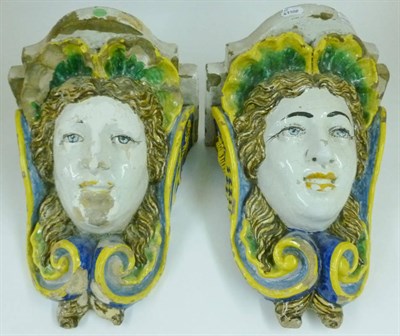 Lot 132 - A Pair of Faience Wall Brackets, possibly French, 18th century, supported by female masks...