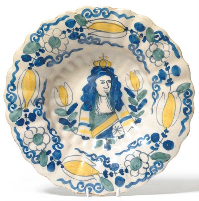 Lot 136 - A Dutch Delft Royal Commemorative Dish, late 17th century, of fluted circular form, painted in...