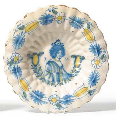 Lot 137 - A Dutch Delft Royal Commemorative Dish, late 17th century, of fluted circular form, painted in...