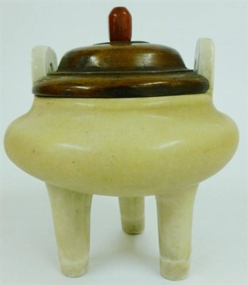 Lot 184 - A Chinese Porcelain White Glazed Tripod Censer, probably Song, of bronze form with a pair of arched