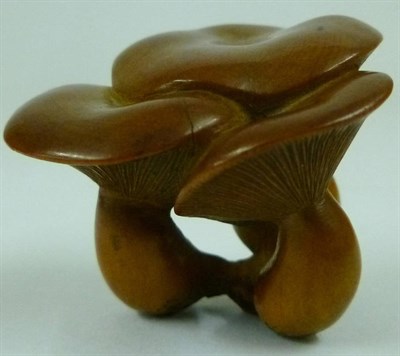 Lot 192 - A Japanese Boxwood Netsuke as a Group of Three Mushrooms, late Meiji period (1868-1912),...