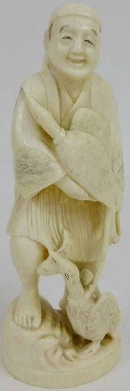 Lot 200 - A Japanese One Piece Carved Elephant Ivory Okimono, late Meiji period (1868-1912), as a smiling and
