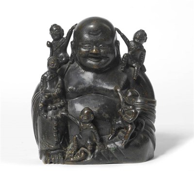 Lot 223 - A Chinese Bronze Figure Group of Budai, 19th century, the corpulent sage seated holding rosary...