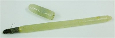 Lot 243 - A Chinese Pale Celadon Jade-Type Carved Pen, early 20th century, the cylindrical stem carved with a