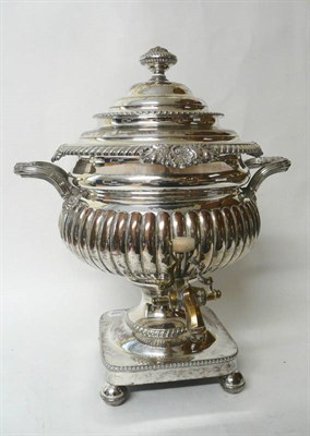 Lot 275 - A George III Sheffield Plate Tea Urn, circa 1815, the square base on four ball feet rising to a...