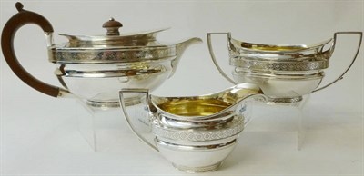 Lot 359 - A George III Three Piece Teaset, John Emes, London 1805, of compressed cape form with wood...