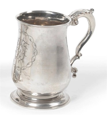 Lot 374 - A George III Mug, maker's mark IM(?), London 1771, of baluster form with cast leaf capped...