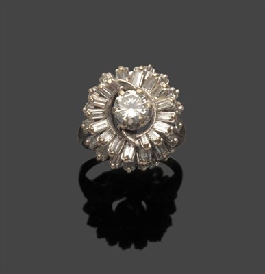 Lot 483 - A Diamond Cluster Ring, a round brilliant cut diamond within a double swirl of baguette cut...