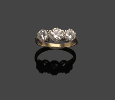 Lot 484 - A Diamond Three Stone Ring, the graduated round brilliant cut diamonds in white claw settings...