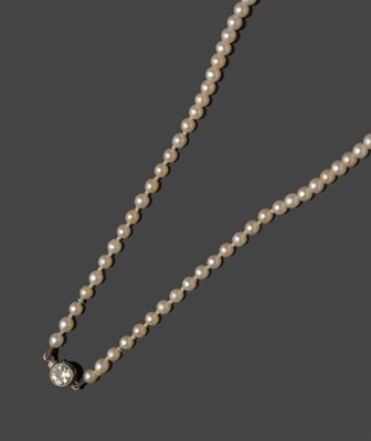 Lot 489 - A Cultured Pearl Necklace, the graduated pearls strung to an old cut diamond solitaire clasp,...