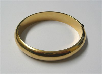 Lot 495 - A Bangle, by Tiffany & Co., the plain polished hinged bangle of hollow D shaped form