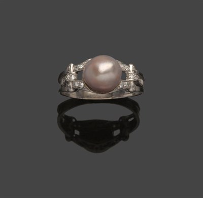 Lot 513 - A Pearl and Diamond Ring, the pearl within pierced diamond set shoulders, to a lined shank,...