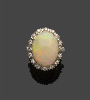 Lot 516 - An 18 Carat Gold Opal and Diamond Cluster Ring, an oval cabochon opal within a border of round...