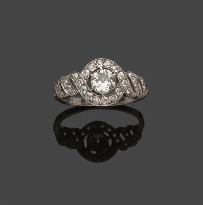 Lot 518 - A Diamond Cluster Ring, a brilliant cut diamond within diamond set scrolling shoulders, in...