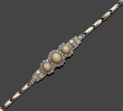 Lot 521 - An Opal and Diamond Bracelet, a triple cluster of cabochon opals within old cut diamond borders...