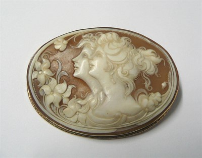 Lot 523 - A Shell Cameo Brooch, carved with two maiden's heads, within a floral decoration, to a...