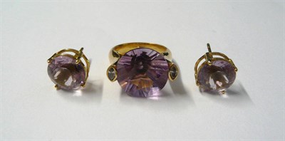 Lot 524 - An Amethyst and Diamond Ring, a round cut amethyst flanked by a marquise cut diamond on each...