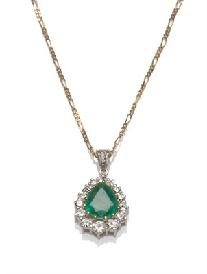 Lot 527 - An 18 Carat Gold Emerald and Diamond Pendant, a pear cut emerald within a border of graduated round