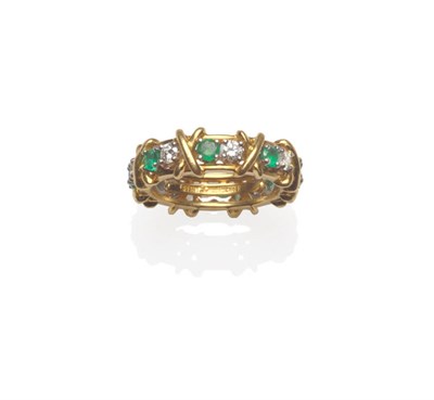 Lot 535 - An 18 Carat Gold Emerald and Diamond Full Eternity Ring, by Tiffany, pairs of round brilliant...