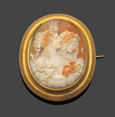 Lot 553 - A Victorian Shell Cameo Brooch, carved to depict night and day, in a rope and bead effect...