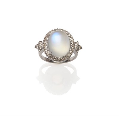 Lot 564 - An 18 Carat White Gold Moonstone and Diamond Ring, a cabochon moonstone within a border of...