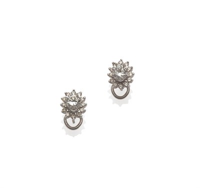 Lot 567 - A Pair of 18 Carat White Gold Diamond Cluster Earrings, round brilliant cut diamonds in claw...