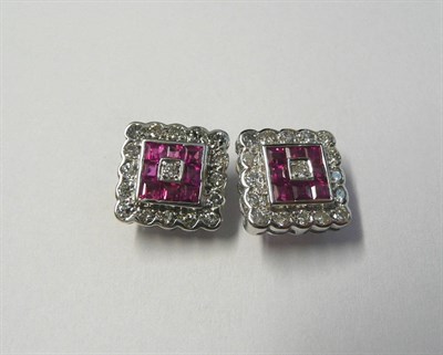 Lot 570 - A Pair of 18 Carat White Gold Ruby and Diamond Cluster Earrings, a round brilliant cut diamond...