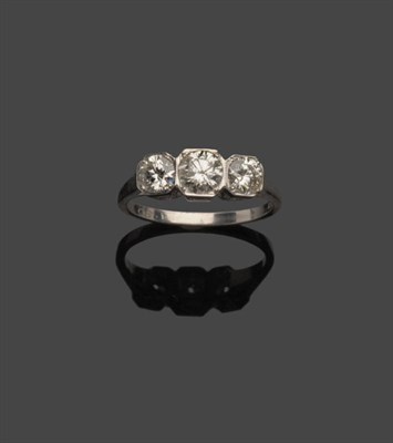 Lot 576 - A Diamond Three Stone Ring, the graduated round brilliant cut diamonds within squared white...