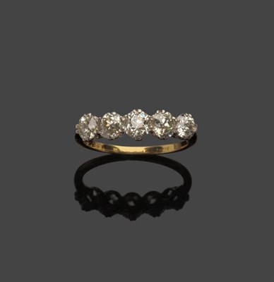 Lot 581 - A Diamond Five Stone Ring, the graduated old cut diamonds in white claw settings to a yellow...