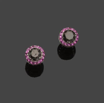 Lot 583 - A Pair of Black Diamond and Pink Sapphire Cluster Stud Earrings, a round brilliant cut black...