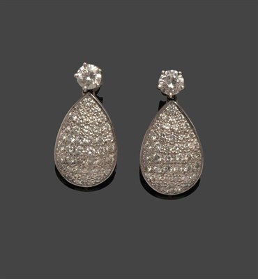 Lot 584 - A Pair of Diamond Earrings, a round brilliant cut diamond in a white claw setting suspends a...