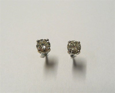 Lot 590 - A Pair of 18 Carat White Gold Diamond Solitaire Stud Earrings, the round brilliant cut diamonds...