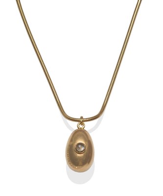 Lot 592 - An Egg Pendant, the plain polished egg set with a cabochon moonstone, hung on a 9 carat gold...